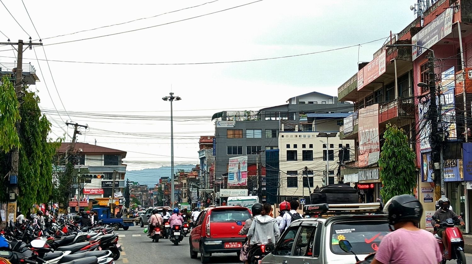 Bustling traffic and urban infrastructure at the central Mahendrapul Chowk intersection in Pokhara Valley
